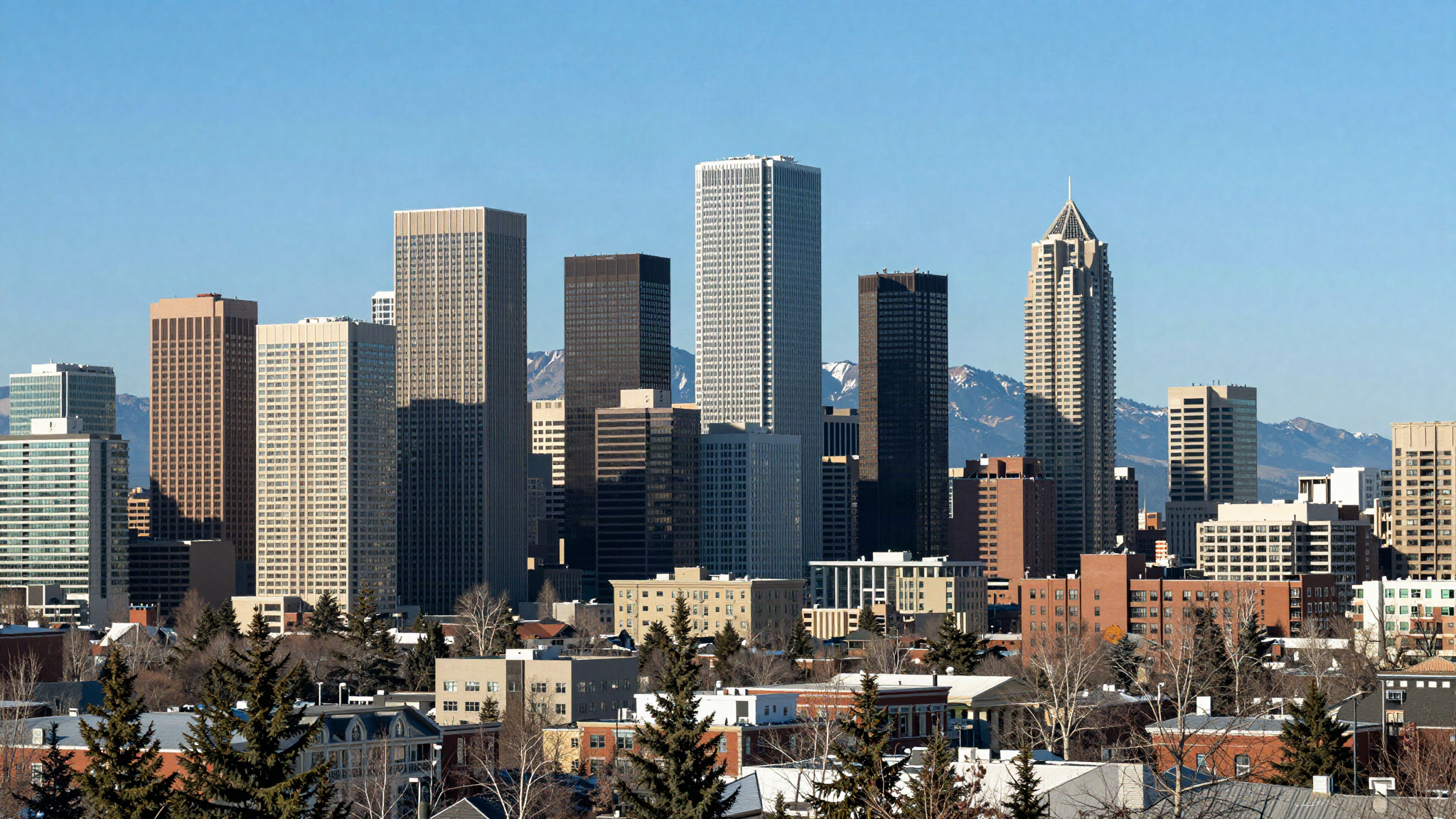 Calgary skyline with the Rocky Mountains on the horizon representing a move to Calgary from the UK